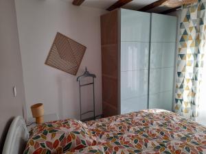 a bedroom with a bed with a colorful comforter at Le lit de la SEINE in Saint-Seine-lʼAbbaye +10 photos