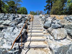 a stone stairway with a bunch of rocks at Lone Pine Oceanfront Cottage in Prospect Harbor