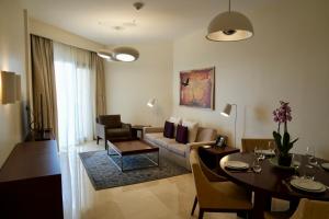 a living room with a couch and a table at InterContinental Hotels Doha Residences by IHG in Doha
