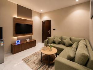 a living room with a couch and a tv at كادي بارك الخليج in Riyadh