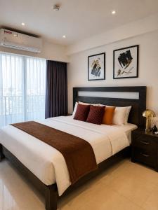a bedroom with a large bed and a window at Luxury at Solaris Appartment in Accra +28 photos