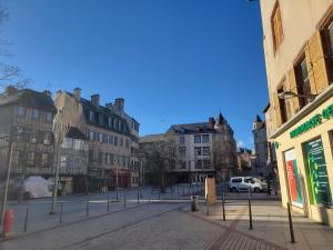an empty street in a city with buildings at Elegant studio Hyper center in Rodez