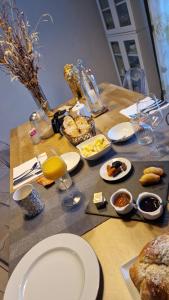 a table with plates of food and glasses of orange juice at La Parenthèse by CHERDECOUVERTE in Sambin