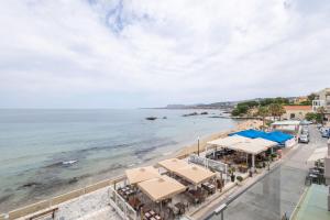 an aerial view of a beach with umbrellas and the ocean at Julies Studios in Chania