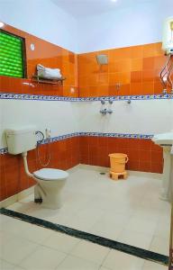 a bathroom with a toilet and a sink at Hotel Sugan Niwas Palace in Jaipur +26 photos