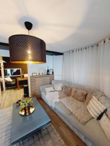 a living room with a couch and a table at La Suite in La Calamine