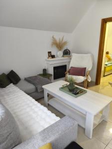 a living room with a couch and a coffee table at Home Delic Komarnica in Šavnik