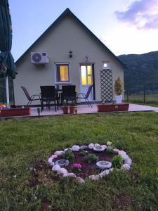 a house with a garden in the yard at Home Delic Komarnica in Šavnik