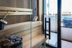 a sauna with a glass door and a tub at MarienHome Loojangu in Haapsalu