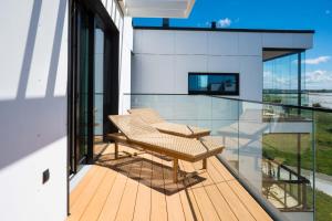 a balcony with a table and chairs on it at MarienHome Loojangu in Haapsalu