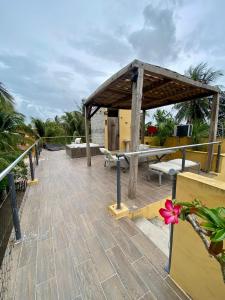a wooden deck with a pavilion on the beach at Casa Tio 1,quiet ground floor apartment in El Cuyo +2 photos