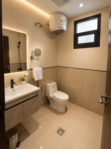 a bathroom with a toilet and a sink and a window at كادي بارك الخليج in Riyadh +19 photos