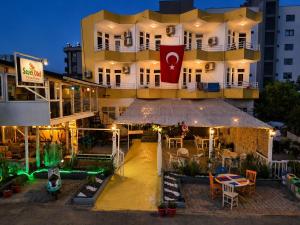 a large building with a restaurant in front of it at FİNİKE SEVER OTEL in Finike