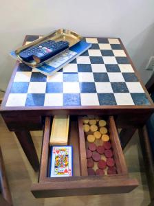 a chess board and remote controls on a table at Entre Muralhas - Cozy Apartment Elvas I in Elvas