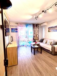 a living room with a couch and a table at studio city center beach side free paddle beautiful terrace in Nice +33 photos