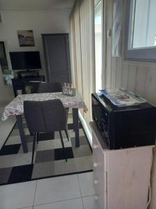 a small kitchen with a table and a dining room at Chambre d'hôtes du Carrousel in La Teste-de-Buch +8 photos
