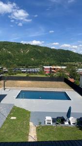 a swimming pool with two lawn chairs next to it at Vila Ali in Krivoglavci