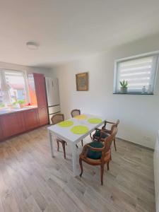 a kitchen with a table and chairs in a room at Apartamenty na Pięknej 24-2 in Nowy Sącz