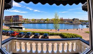 a balcony with a bunch of cars parked in a parking lot at Hotel Le Beau Rivage in Middelburg