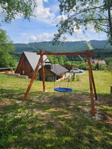 a swing set in the middle of a field at Vikendica IVA in Pale
