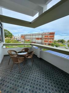 a balcony with a table and chairs on a building at RY Homestay in Tawau