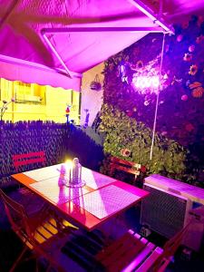 a table in a room with purple lights at studio city center beach side free paddle beautiful terrace in Nice