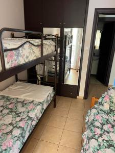 two bunk beds in a room with a mirror at Aqua Mare Seaside Experience in Pyrgadikia