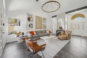 a living room with a couch and chairs at NEW Royal Palms Retreat with Pool Spa & Pool Table in Tempe