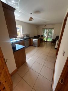 a large kitchen with a large tiled floor at Golf central in Rosslare Harbour