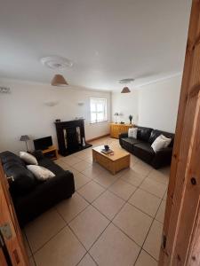 a living room with two couches and a coffee table at Golf central in Rosslare Harbour