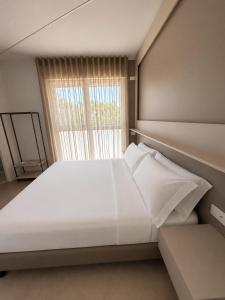 a large white bed in a room with a window at GG Landlords Room & Spa in Vasto