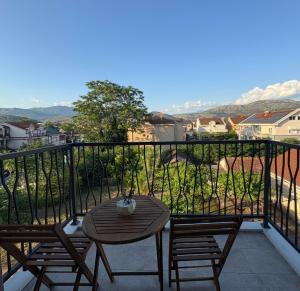 a table and chairs on a balcony with a view at D&M Lux2 in Podgorica +5 photos