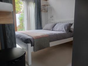 a small bed in a room with a window at Oak framed appartment in Chester
