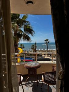 a patio with a table and chairs and the beach at Apartment in Durres Elio in Golem