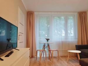 a living room with a table and a large window at Cichy Kącik in Wadowice