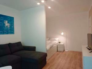 a living room with a couch and a bed at Cichy Kącik in Wadowice +6 photos