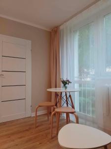 a room with a table and two chairs and a window at Cichy Kącik in Wadowice