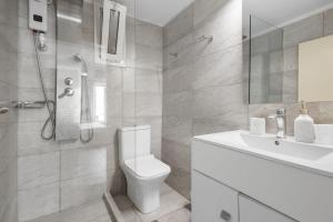 a white bathroom with a toilet and a sink at Julies Studios in Chania +23 photos