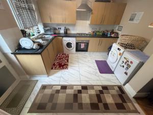 a small kitchen with a washer and dryer at House 220 in London +59 photos