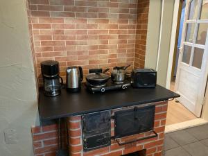 a stove with pots and pans on top of it at Jaani 2-1 Apartment in Pärnu +16 photos
