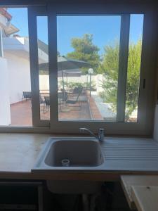 a kitchen sink with a view of a patio at B&B BELLAMI' in Tuglie +62 photos