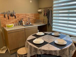 a kitchen with a table with plates on it at Jaani 2-1 Apartment in Pärnu