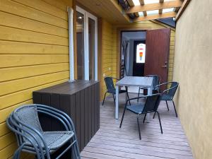 a patio with chairs and a table on a deck at Jaani 2-1 Apartment in Pärnu