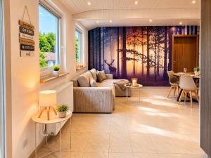 a living room with a couch and a table at PrimeLoft Apartments am Kurpark in Braunlage