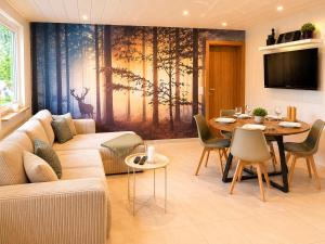 a living room with a couch and a table at PrimeLoft Apartments am Kurpark in Braunlage +95 photos