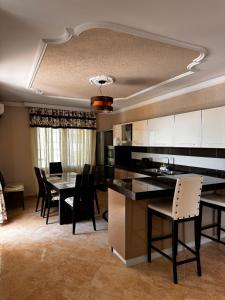 a kitchen and dining room with a table and chairs at Apartment in Durres Elio in Golem