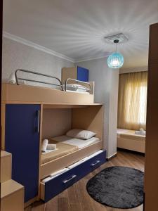 a room with two bunk beds and a rug at Apartment in Durres Elio in Golem