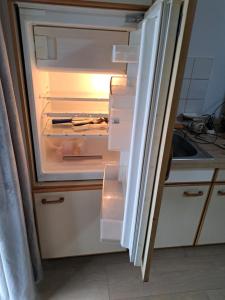 an open refrigerator with its door open in a kitchen at MHm in Passau
