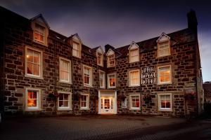 a large brick building with white doors and windows at The Royal Hotel in Comrie