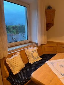 a bedroom with a bed and a large window at Panoramic Alpine Residence in Eisenerz